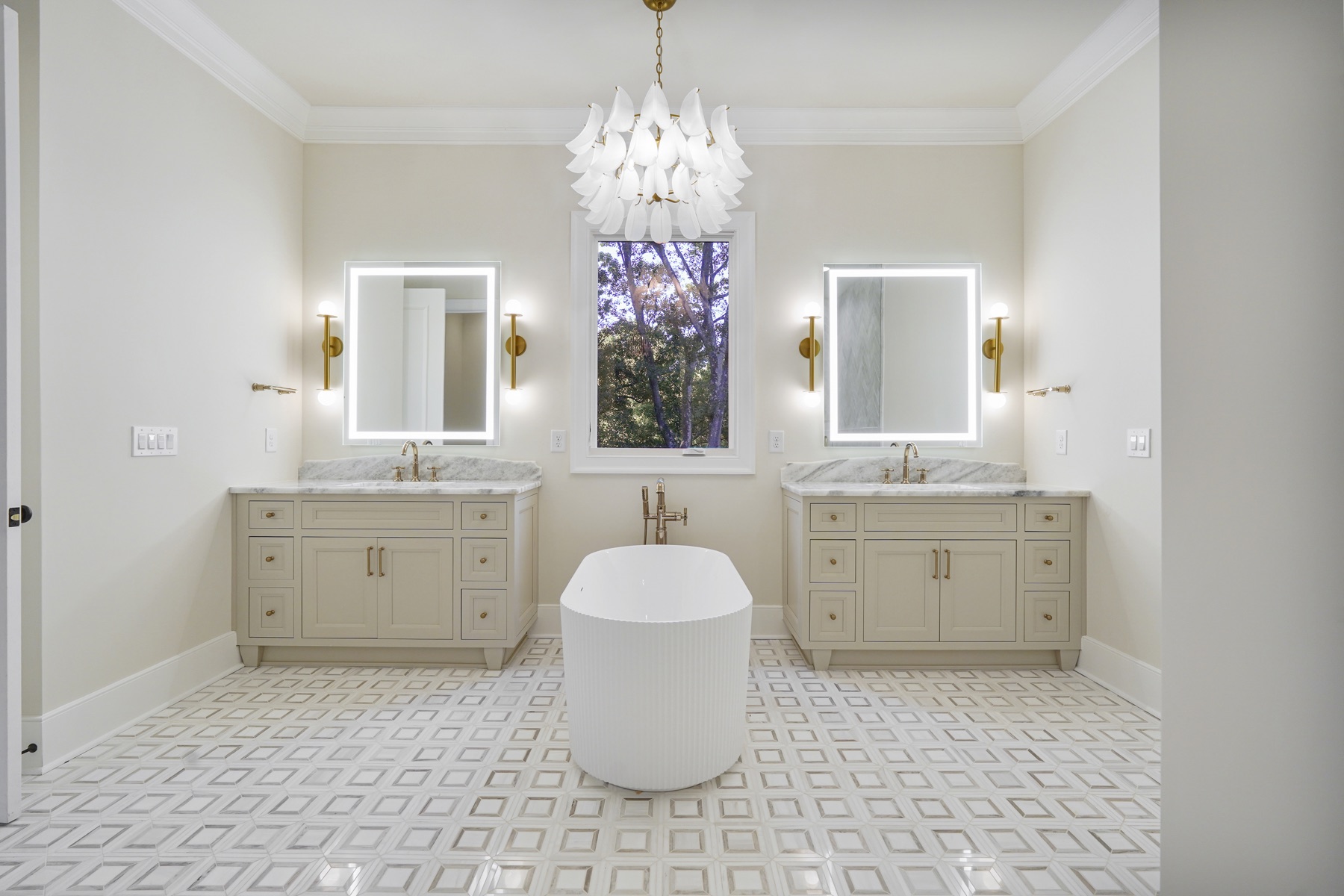 Primary bathroom with two illuminated vanity mirrors