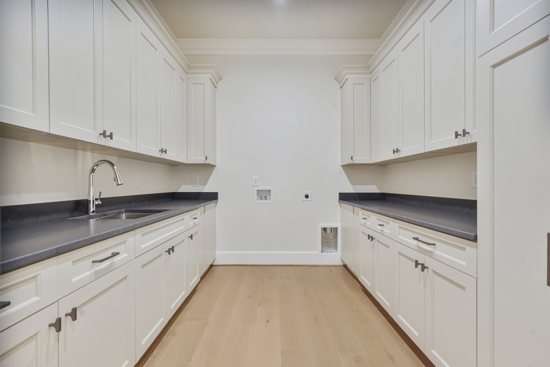 Laundry room with white cabinets