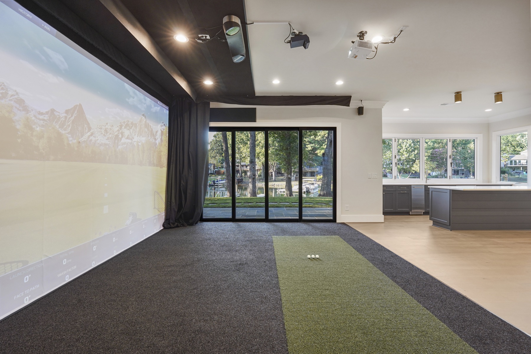 Recreation room with a golf simulator