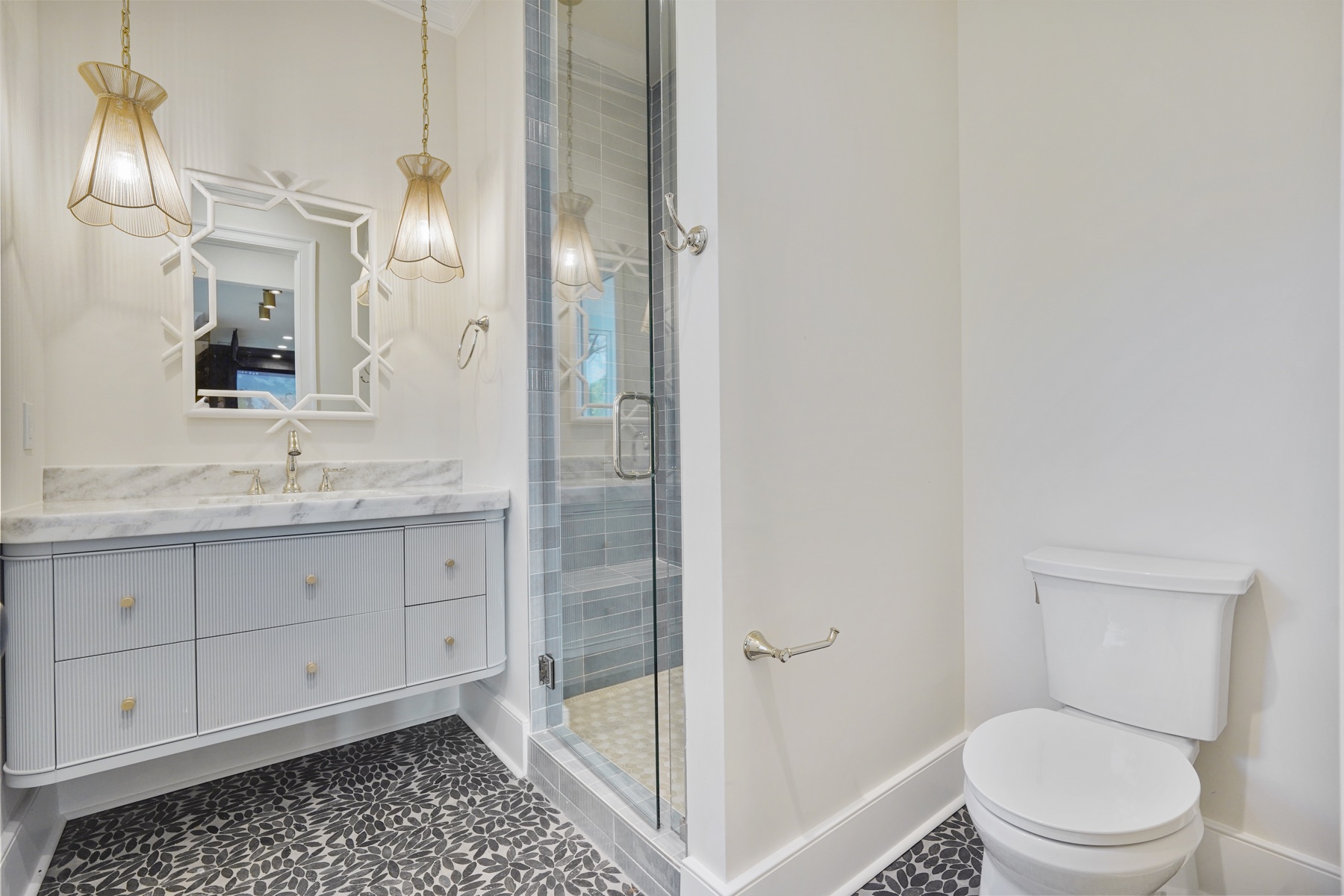Bathroom with a decorative vanity and glass shower