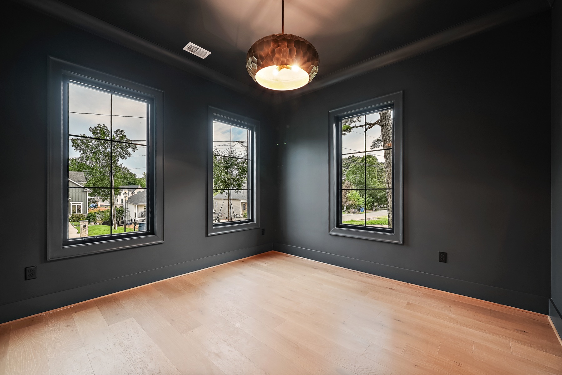 Room with dark walls and large windows