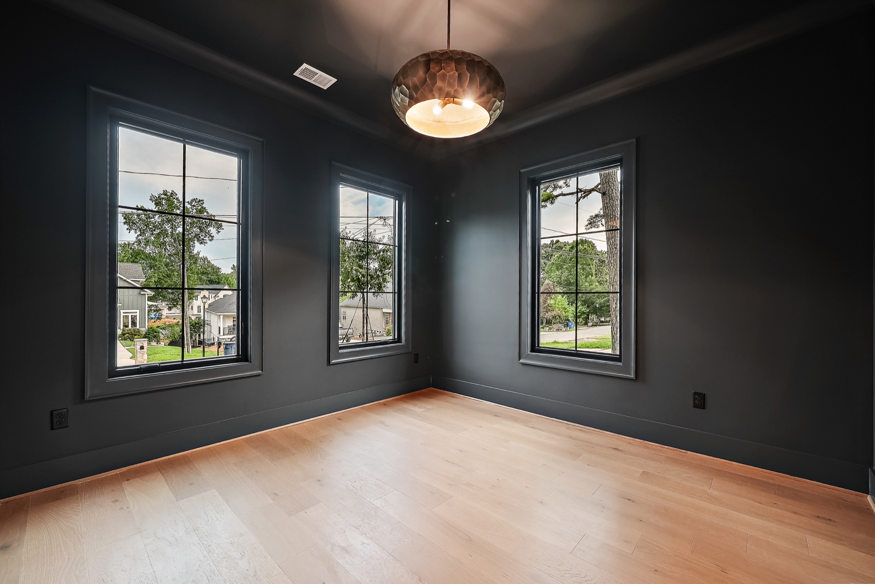 Another view of a room with dark walls and large windows