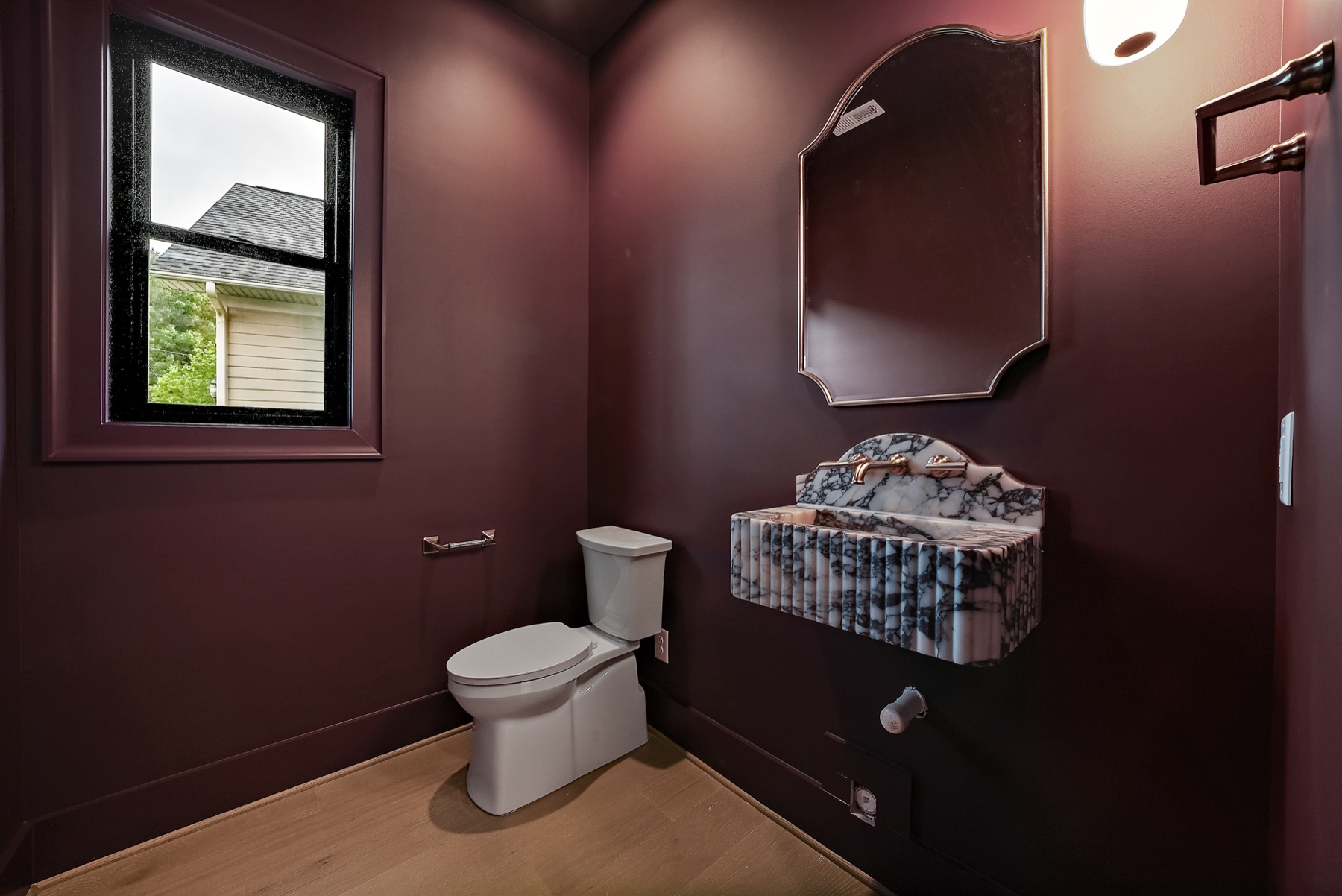 Powder room with a dark painted vanity