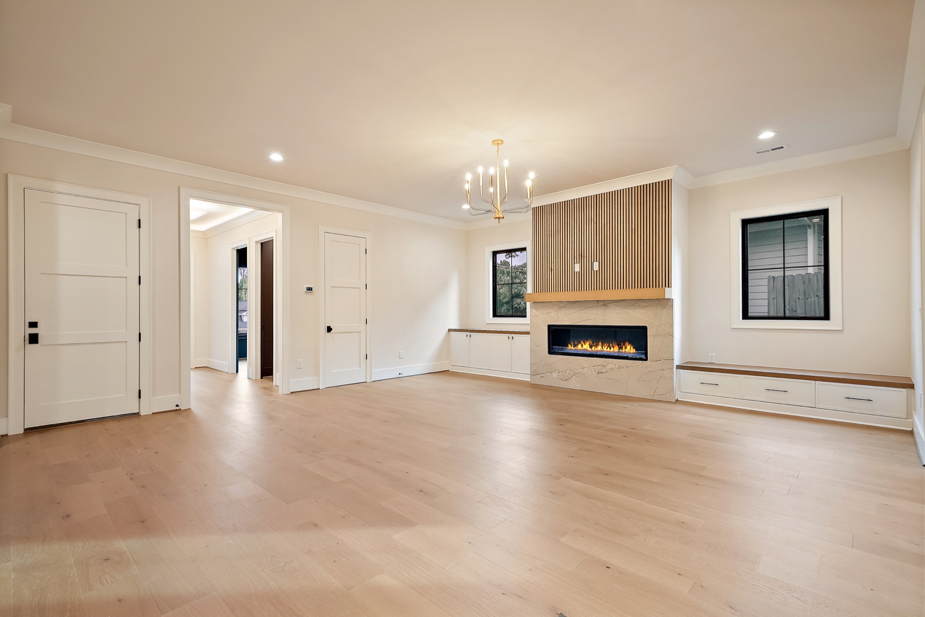 Living room with a fireplace and chandelier