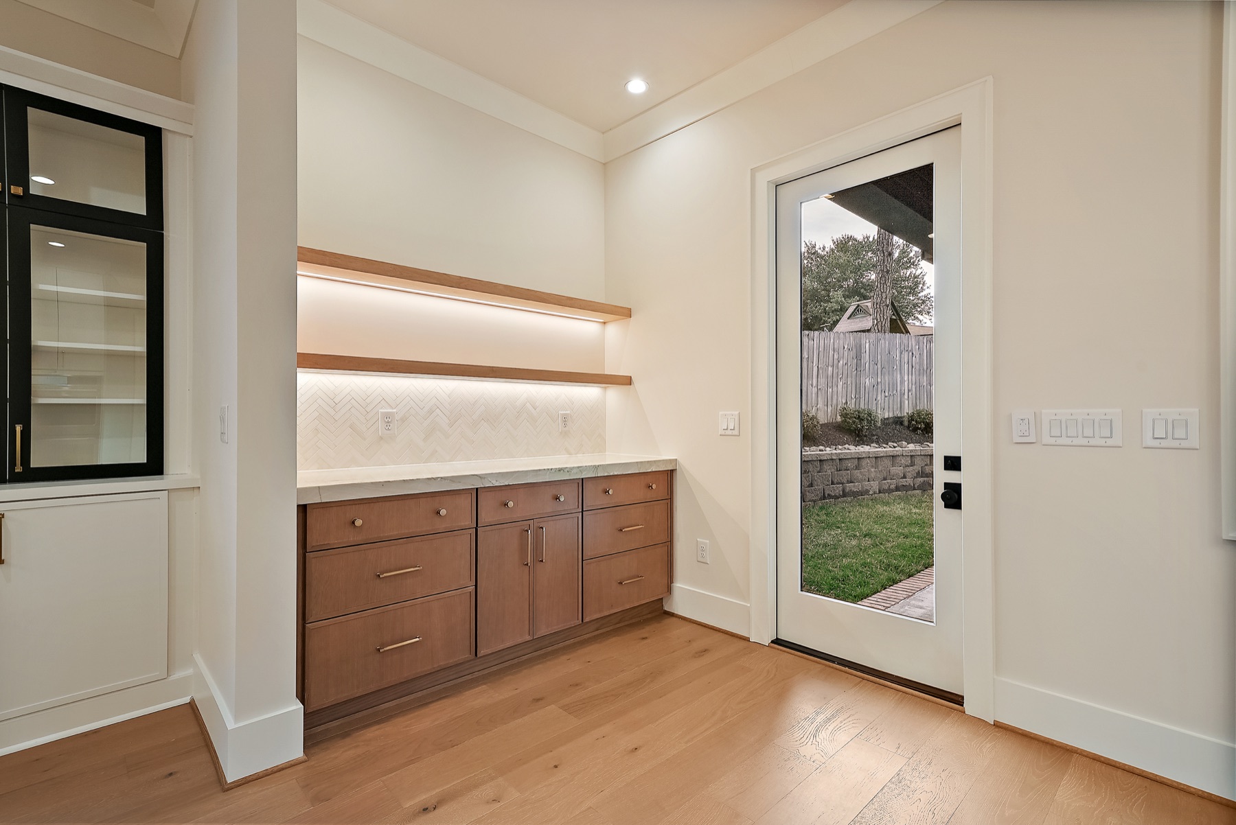 Built-in cabinetry beside a glass door