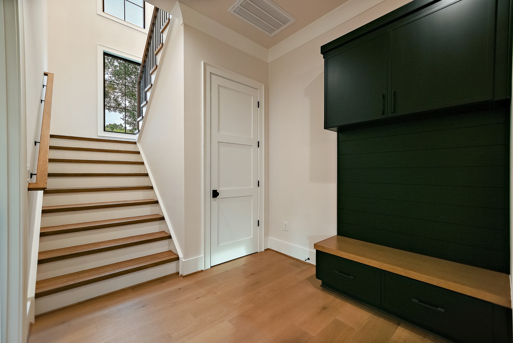 Staircase and entryway with wood floors