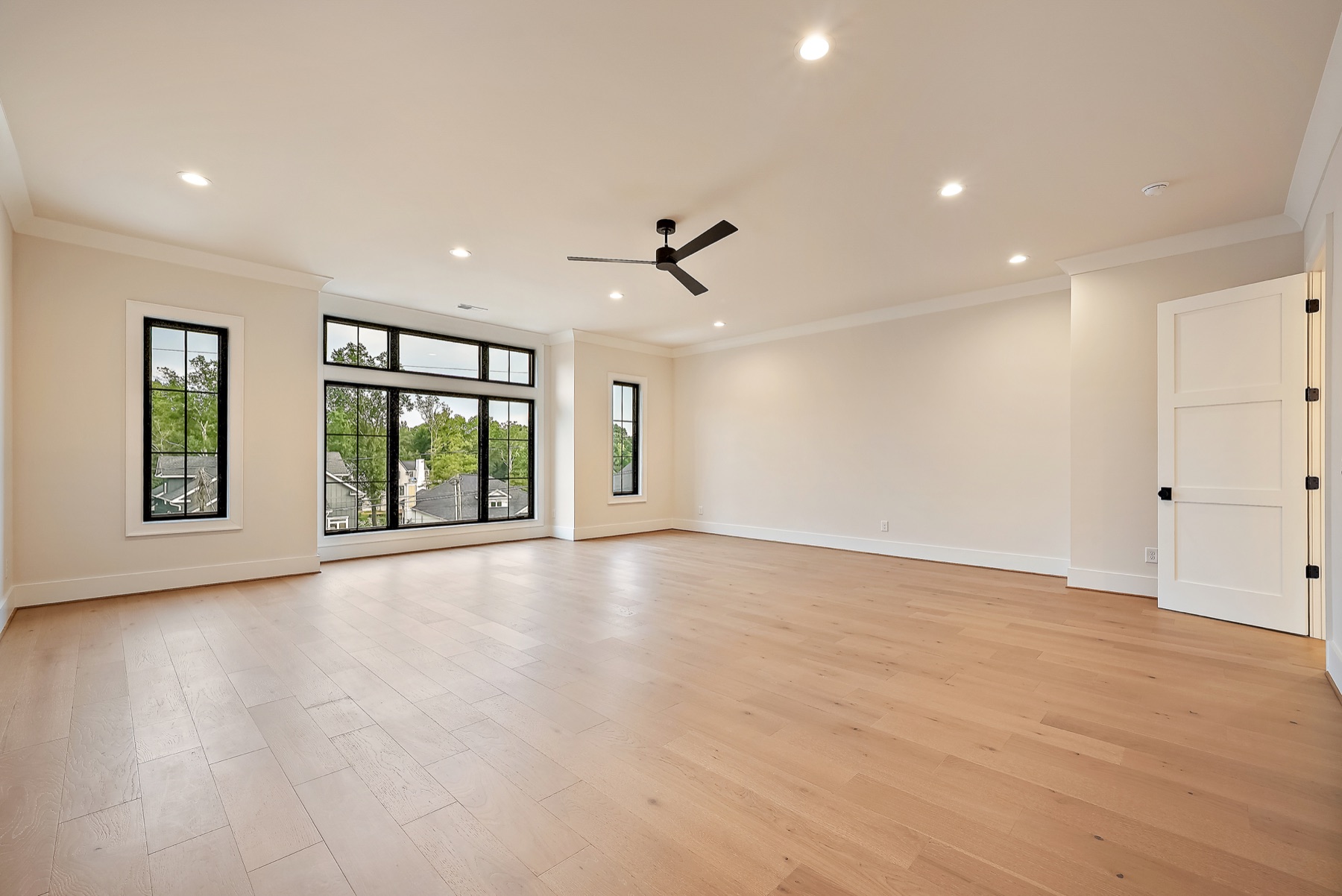 Bedroom with wood floors and large windows