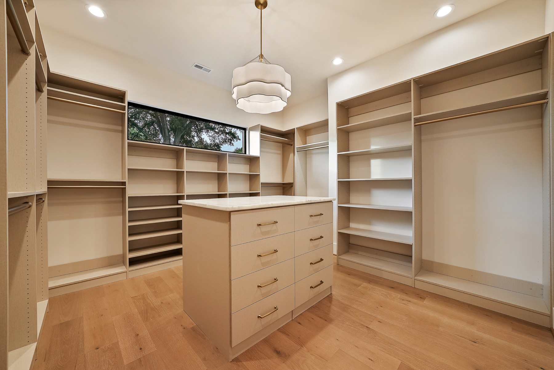 Walk-in closet with shelving and drawers
