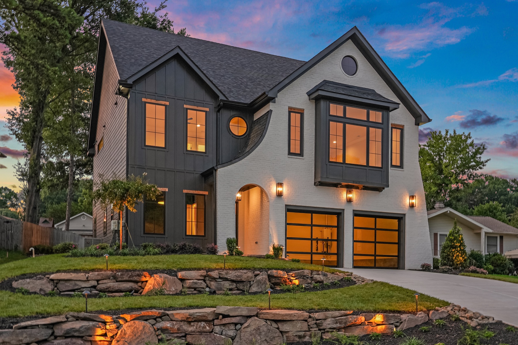 Front exterior of a BWA Builders custom home at dusk